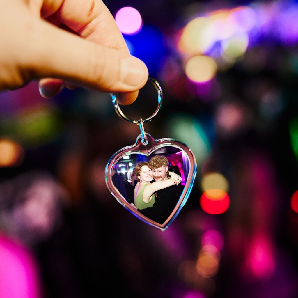 Personalised heart photo keyring held up by its ring